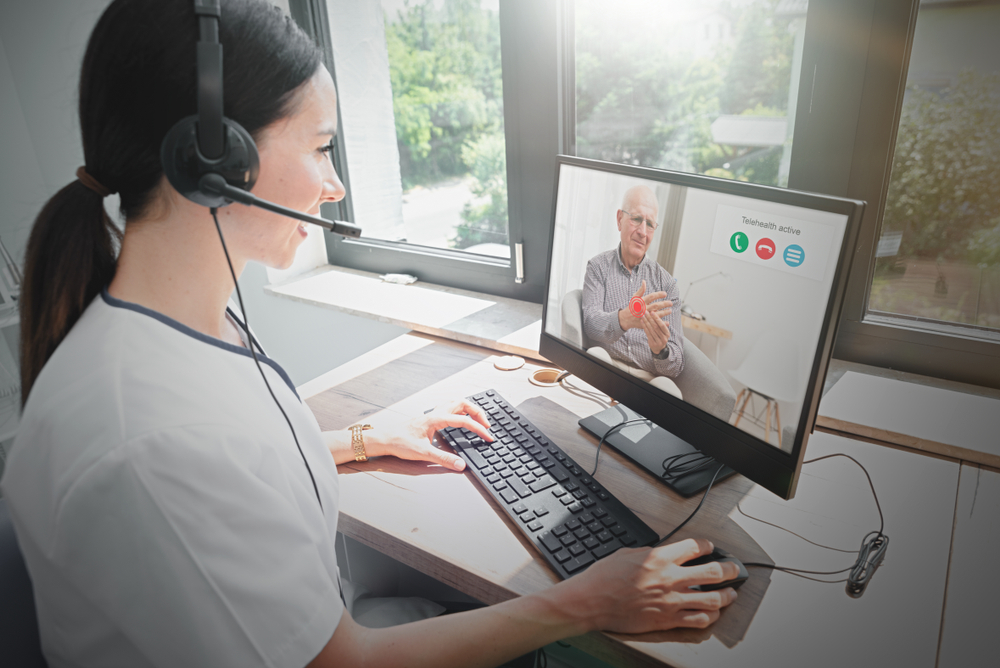 Female doctor on video call with elderly man