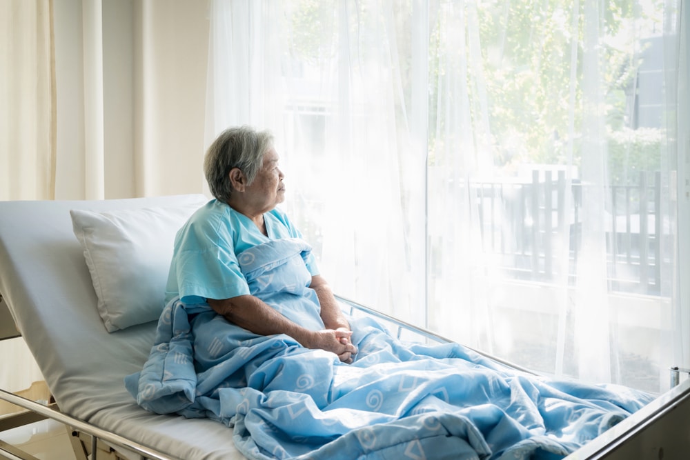 Asian,Depressed,Elderly,Woman,Patients,Lying,On,Bed,Looking,Out patient staring out of window