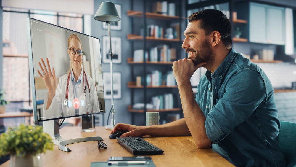 Man on video call with female doctor